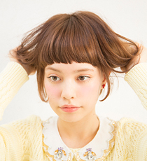 毛先から中間を握るようしてワックスをなじませる。ムラにならないよう、全体にまんべんなく揉み込んで。その後手に残ったワックスを使い、前髪の毛先を少しずつつまんで整える。